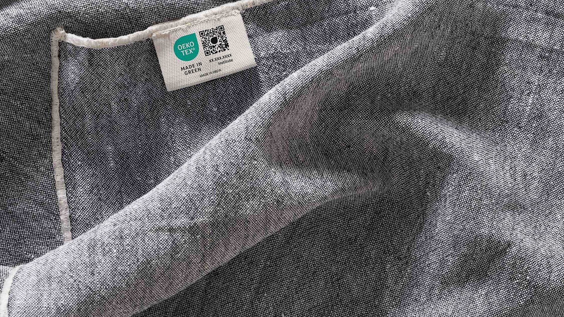 Grey fabric with a woven MADE IN GREEN label